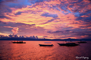 Sunset in Moalboal by Raoul Caprez 